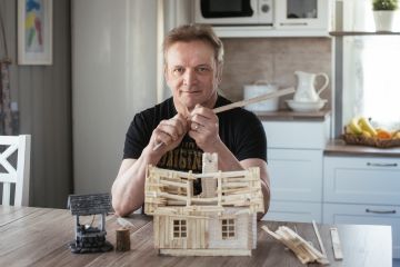 Antti Haarala rakentaa suurimman osa pienoismalleista keittiönpöydän äärellä. Rakennustarpeet työstetään pihaverstaassa. (Kuvaaja: Minna Haarala)